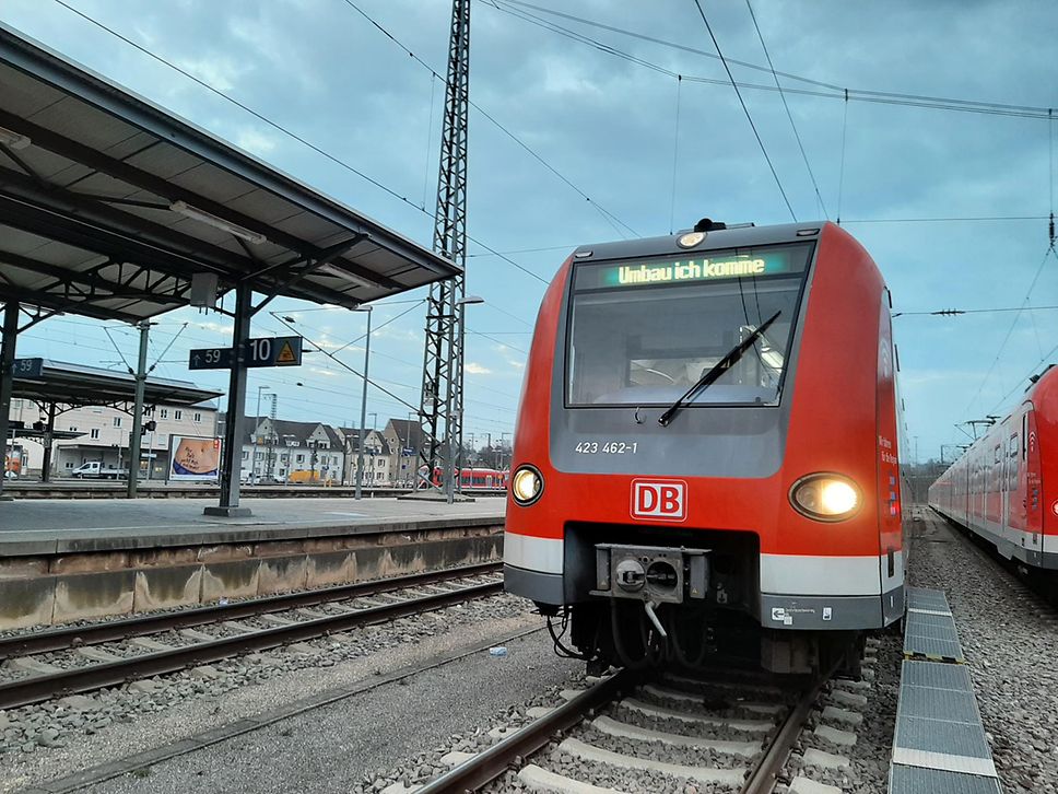 Eine rote S-Bahn steht am Bahnsteig und im Zielführer steht "Umbau ich komme!"